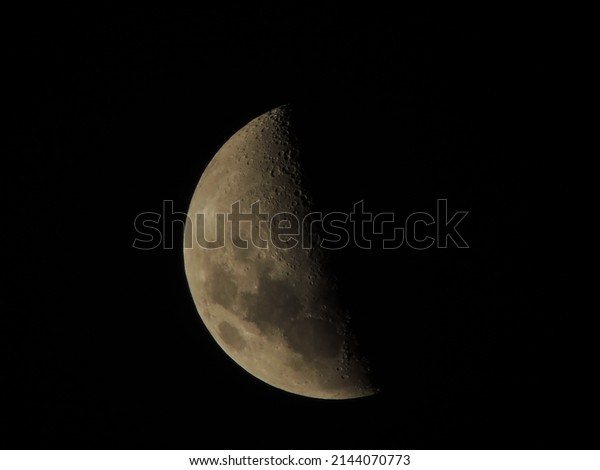 moon one day before its crescent\
phase, not very bright and with dark sky in the\
background
