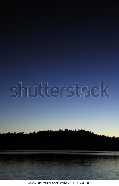 Moon over a\
lake