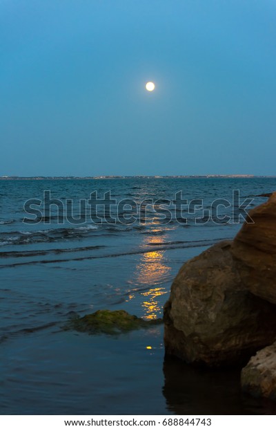 Moon over\
sea