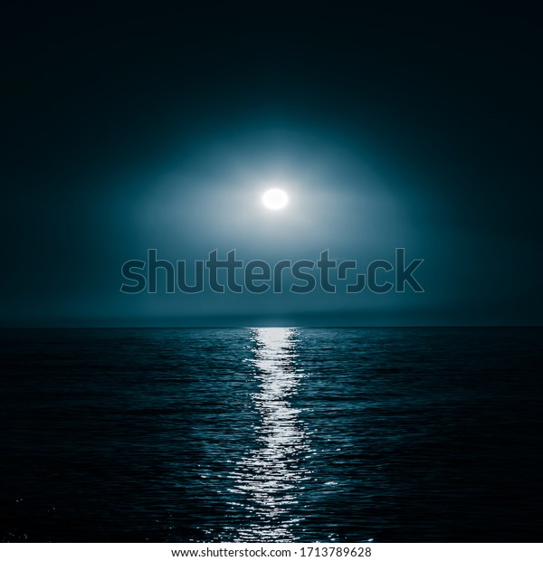 Moon over the sea.\
Moonlight on the sea. Night sky. A patch of moonlight on the\
surface of the night sea.