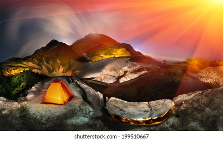 Moon over the top of Pop Ivan Maramorosh  lonely figure, drawing a powerful LED flashlight pictorial compositions of the alpine lake, where icebergs float. Magical land beckons tourists with its magic - Powered by Shutterstock