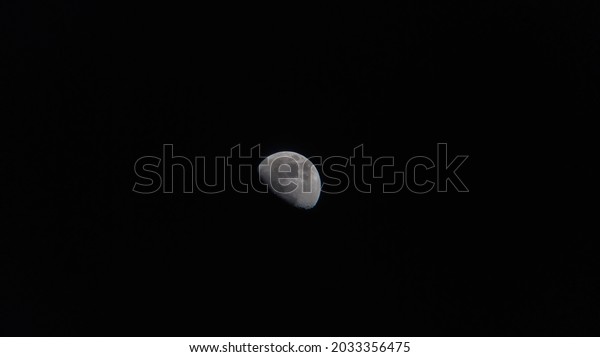 moon piece in dark sky, dark black background.\
moon piece, moon at night.