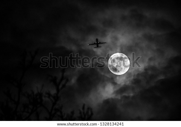 Moon with Plane passing\
overhead 