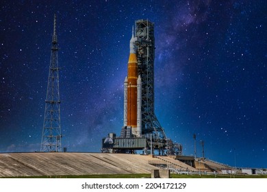 Moon rocket with crew capsule on launch pad in preparation for launch. Primary source, elements of this image furnished by NASA.