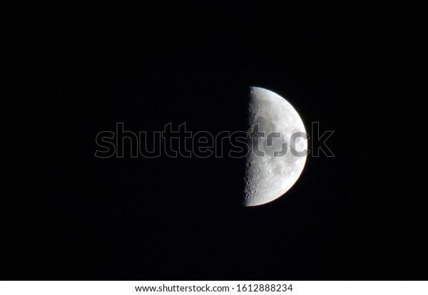 The moon is a satellite of the earth. A\
month or incomplete the moon in close-up.Craters and lakes of the\
moon are clearly visible.Semi-lunar background.The only natural\
satellite of the planet\
Earth.