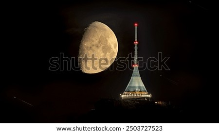 The moon sets behind Jested, an amazing and rare night spectacle by the city of Liberec, Czech republic. Jizerske mountains and Liberec. The best photo.