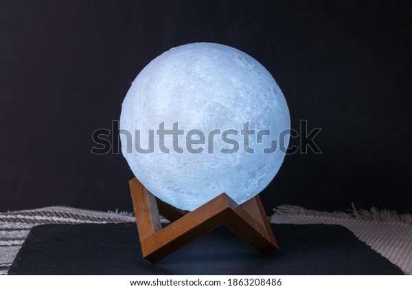 moon shaped night light glows in the dark. decor\
for the home. selective\
focus