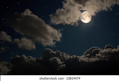 The moon shines in the star night sky among thunderclouds. - Powered by Shutterstock