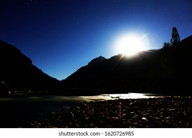 The moon shining over a river inside the Himalaya  - Powered by Shutterstock