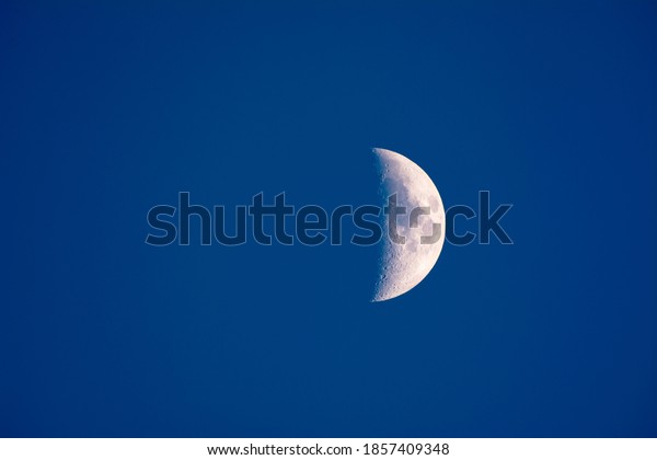 The moon shot just before dark shows a partial\
planet and blue atmosphere. Good image where you can place copy to\
the left of the moon.