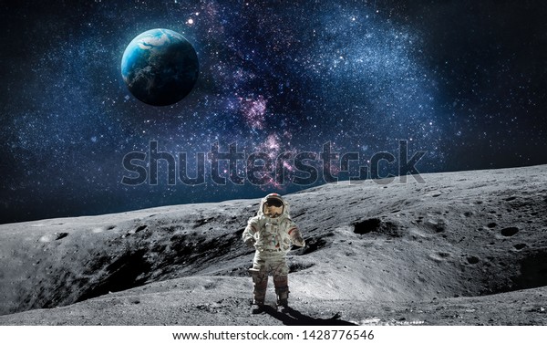 Moon surface with astronaut on it. Planet Earth on\
the background. Apollo space program. Elements of this image\
furnished by NASA.