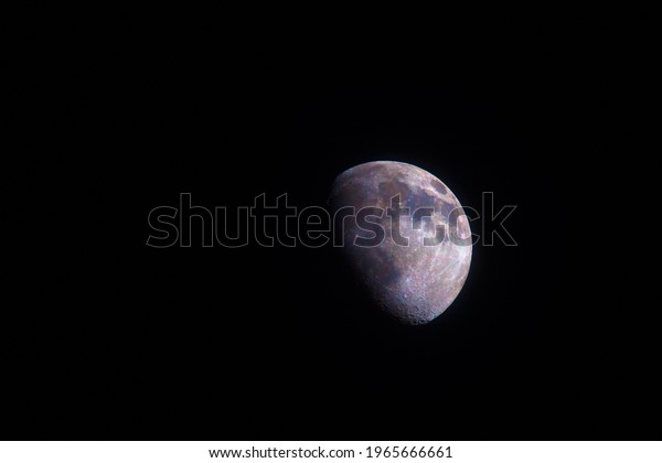 Moon\
two thirds 66%  phase photographed through a long focal telescope.\
Scientific colored for better understanding of minerals and surface\
geology - each color represents different\
material.