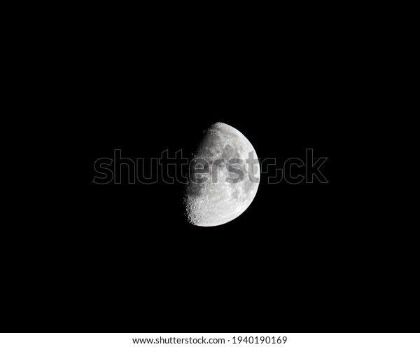 A moon\
view, showing its details and darker\
side.