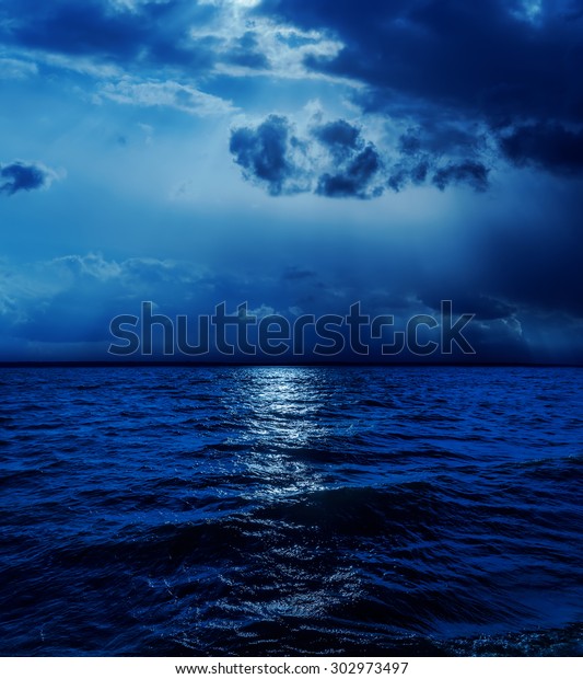 moonlight in clouds over\
water