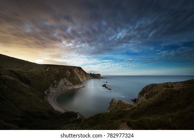 Moonlight over the Dorset Coast as the moon rises at Man O War Cove, Durdle Door, Lulworth