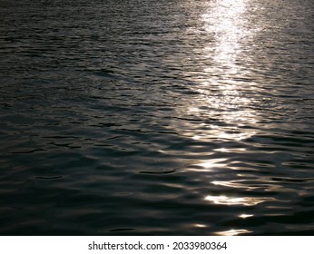 The Moonlight Shines On The Surface Of The Water.   Sunset Light On The River At Dusk  