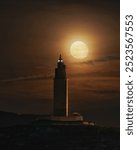 Moonrise behind the tower of hercules