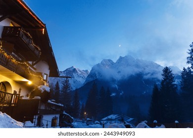 Moonrise over mountain range, snow-capped peaks illuminated by moonlight - Powered by Shutterstock
