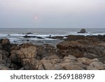 Moonset at dawn. Northern portuguese rocky coast.