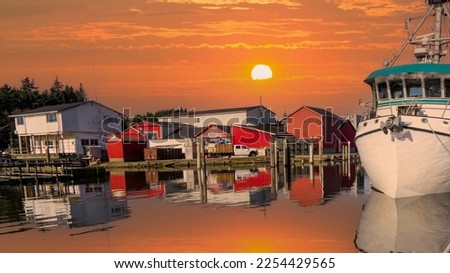 A moorage basin at sunset, at the mouth of the Columbia River at Ilwaco, Washington State for commercial fishing boats.