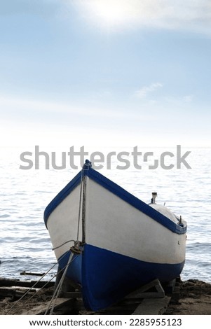 Moored boat on beach near sea outdoors