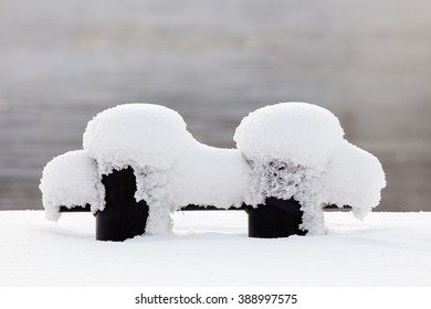 Mooring Bollard Covered With Snow On A Cold Winter Day.