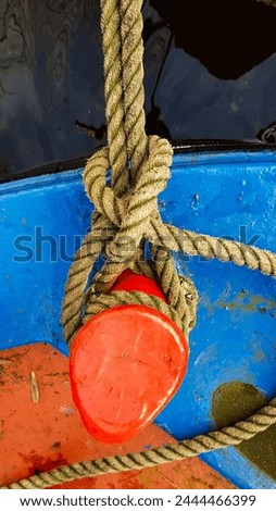 Mooring Rope Knot on red stern post of blue narrowboat deck