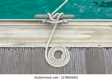 Mooring rope with a knotted end tied around a cleat