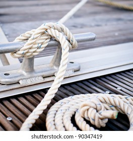Mooring rope/ White mooring rope tied around steel anchor on boat or ship