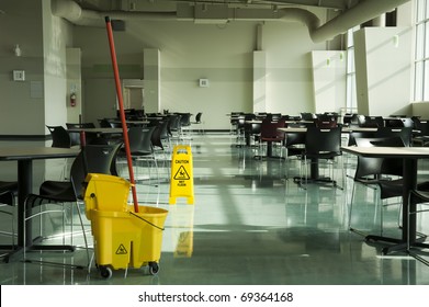 A mop, bucket and caution sign in a cafeteria environment - Shutterstock ID 69364168