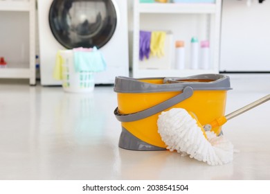 Mop And Bucket For Cleaning And Mopping The Floor In Laundry Room At Home, Clean Up Housework Concept.