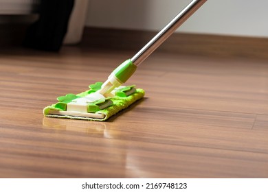 Mop cleaning dirty wood floor, household mopping, cleaning background. - Shutterstock ID 2169748123