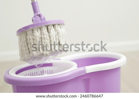 Mop with cleaning solution inside the house