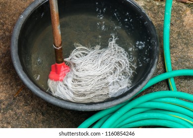 The Mop Is Immersed In A Bath. Cleaning With Water
