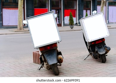 Mopeds parked on the roadside, rear view. Moped service delivery. Pack sign with copy space. Mock-up service delivery.