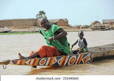 MOPTI, MALI, AFRICA - SEPTEMBER, 3, 2011 Father and son on his boat 