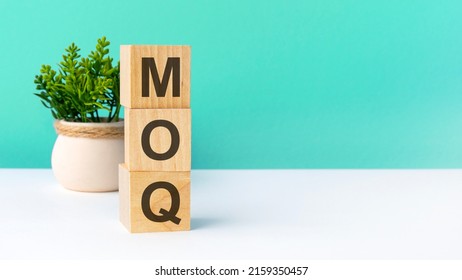 moq - word from wooden blocks with letters. business concept on green background. copy space available. moq acronym - minimum order quantity - Shutterstock ID 2159350457