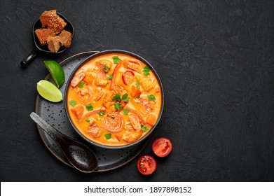 Moqueca With Fish And Shrimps In Black Bowl On Dark Slate Table Top. Brazilian Sea Food Curry Dish With Coconut Milk And Vegetables. Top View. Copy Space