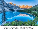 Moraine Lake in Alberta Canada 
 - Beautiful Sunrise with Lighted Mountain Peaks, Incredible Reflection and Amazing Blue Water