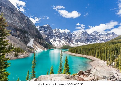 Moraine lake in Banff National Park, Canadian Rockies, Canada. Sunny summer day with amazing blue sky. Majestic mountains in the background. Clear turquoise blue water.