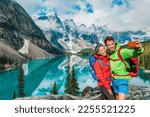 Moraine lake Couple tourists taking selfie picture on Canada travel hike using phone. Young hikers happy using phone on Banff holiday