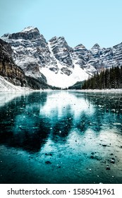 Moraine Lake Panorama In Winter With Frozen Water And Snow Covered Mountains, Banff National Park, Alberta, Canada