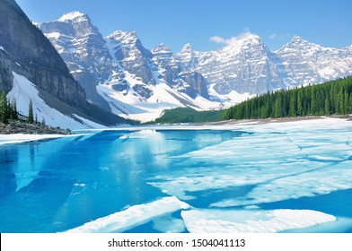 Moraine Lake Under The Ice At Morning Spring Time. Banff National Park. Canada.