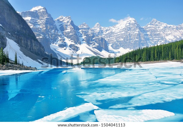 Moraine lake under the ice at morning spring\
time. Banff National park.\
Canada.
