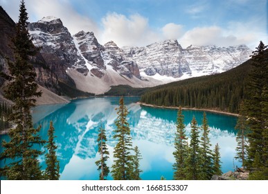 Moraine lake view with snowy mountains reflecting in clear blue water - Powered by Shutterstock