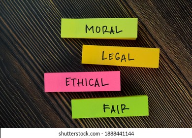 Moral - Legal - Ethical - Fair write on sticky notes isolated on Wooden Table.