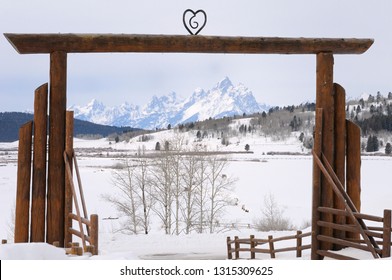 Moran, Wyoming, United States - February 22, 2009: Gate Arch Of Heart Six Ranch In Buffalo Valley In Winter Framing Grand Teton Peaks Wyoming