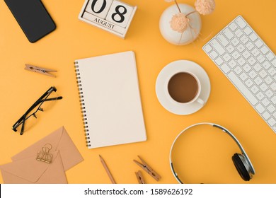 Mordern Workplacewith Keyboard, Headphone, Coffee, Glassess, Phone, Pen On Orange Background. Top View, Flatlay.