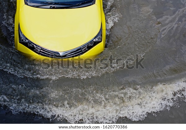 more floods and flooded cars ,car driving flood
water on a road