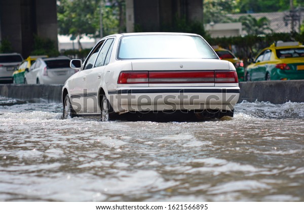more floods and flooded cars ,car driving flood
water on a road